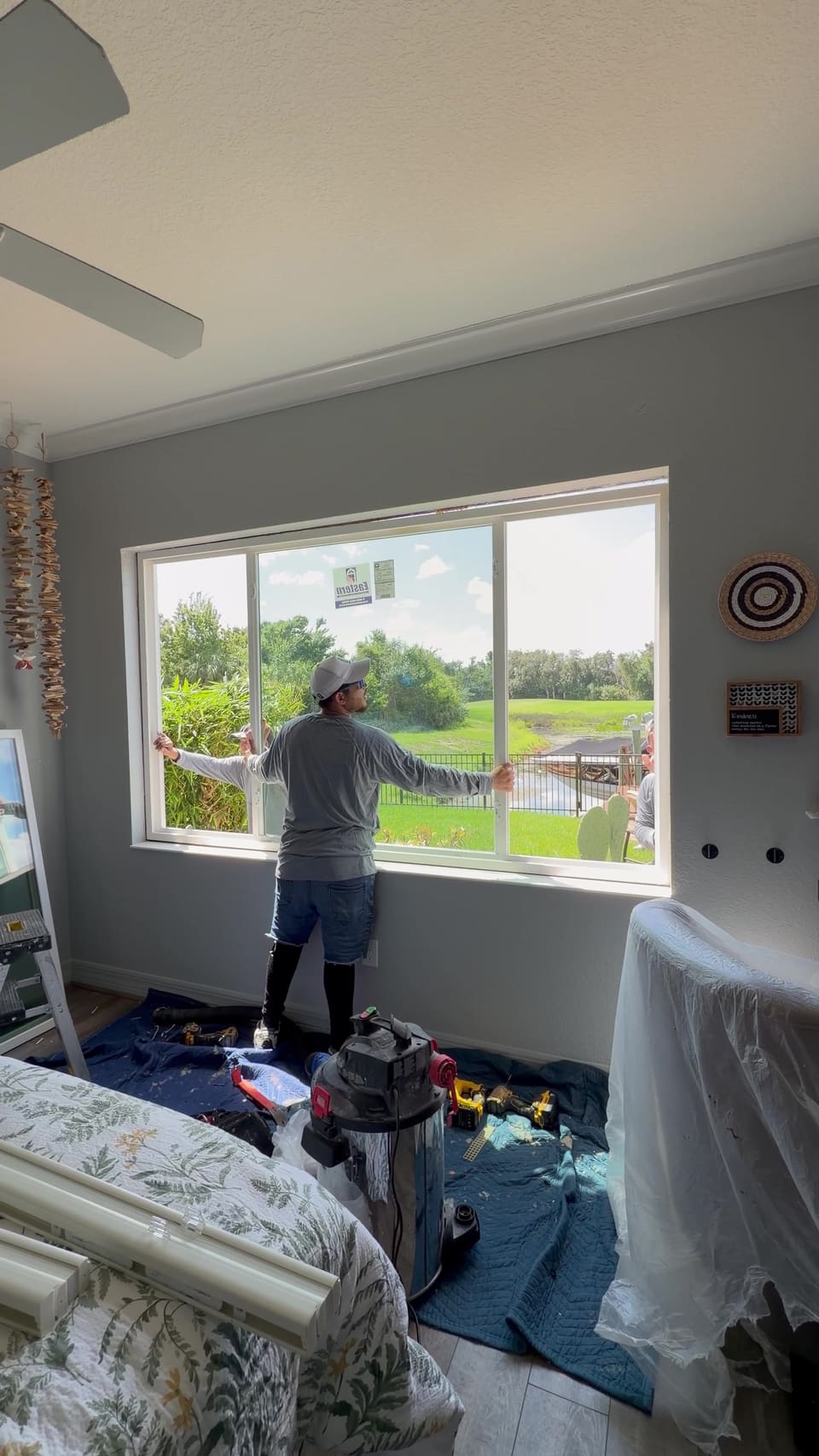 Installer checking a finished sliding window with a lake view